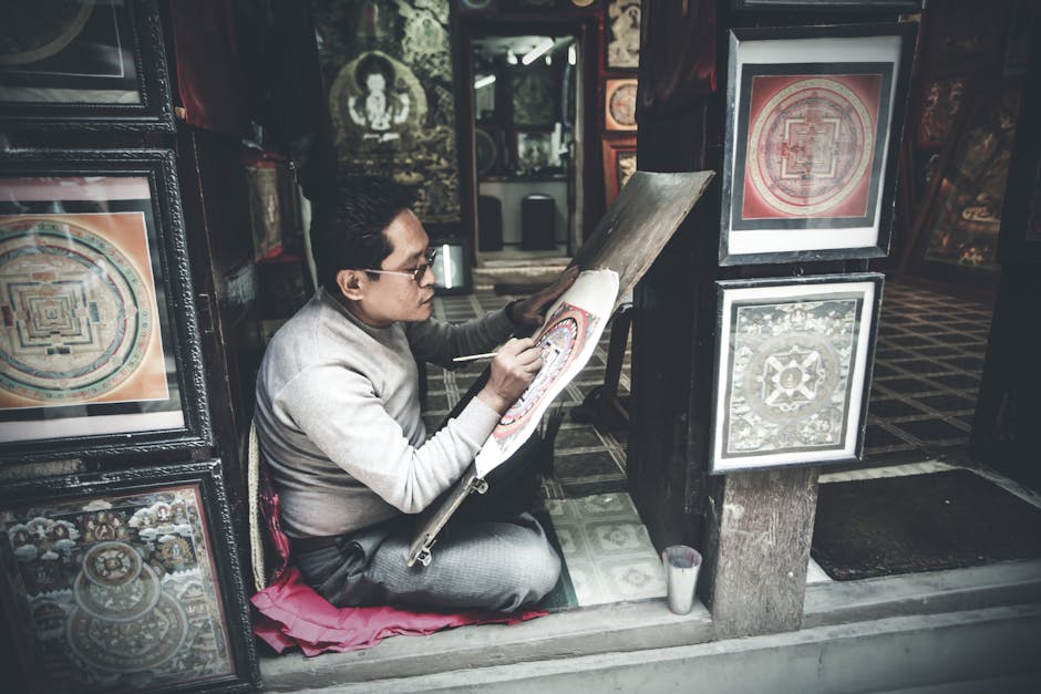 Side view full length focused Asian male artist in casual clothes drawing traditional paintings in authentic art studio