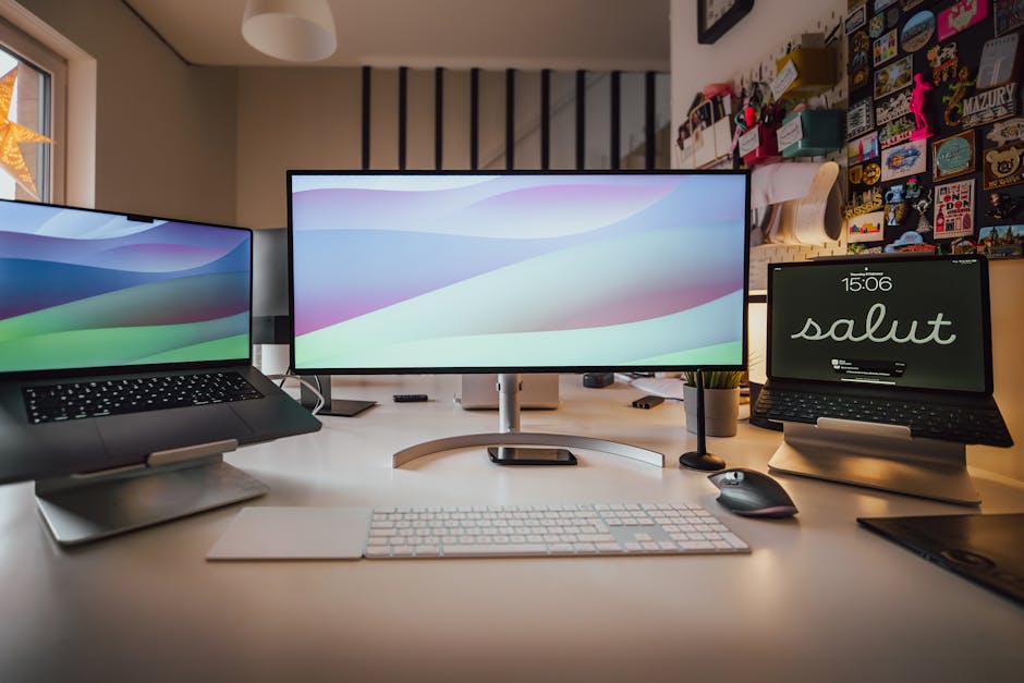 A well-organized home office setup featuring multiple screens and a tidy workspace.