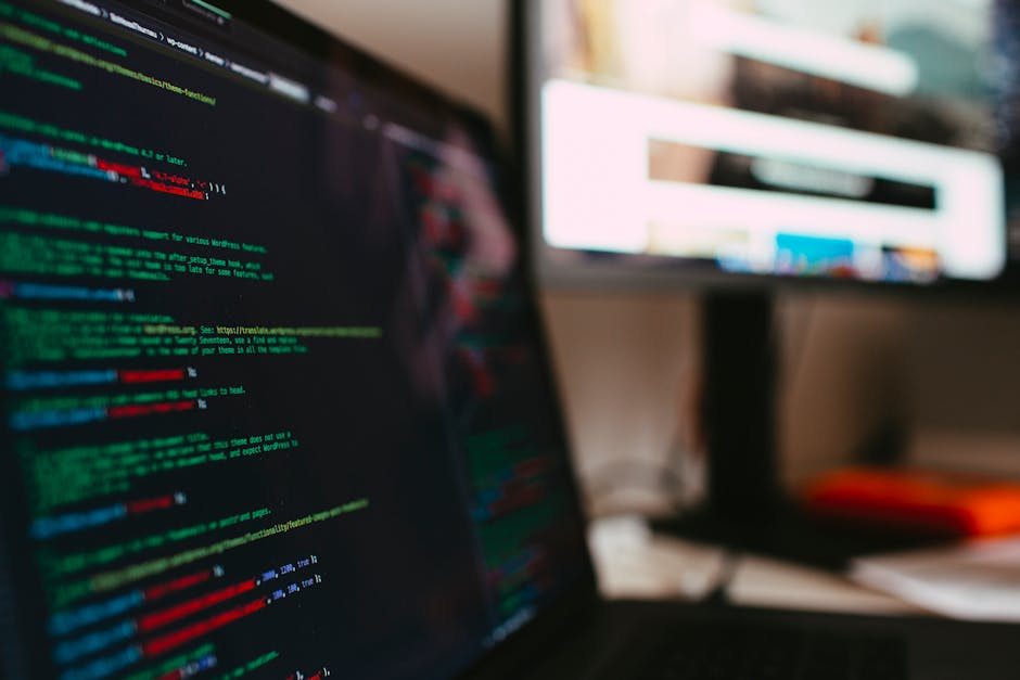 A detailed view of programming code displayed on a laptop screen, depicting a tech workspace.