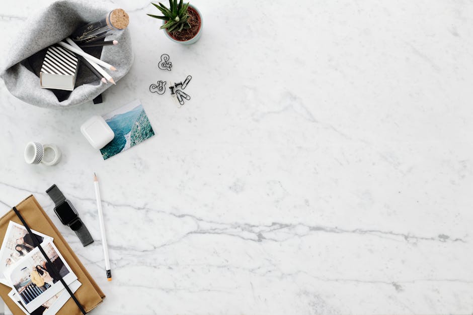 A clean and stylish flatlay of a workspace on marble with various items providing ample copy space.