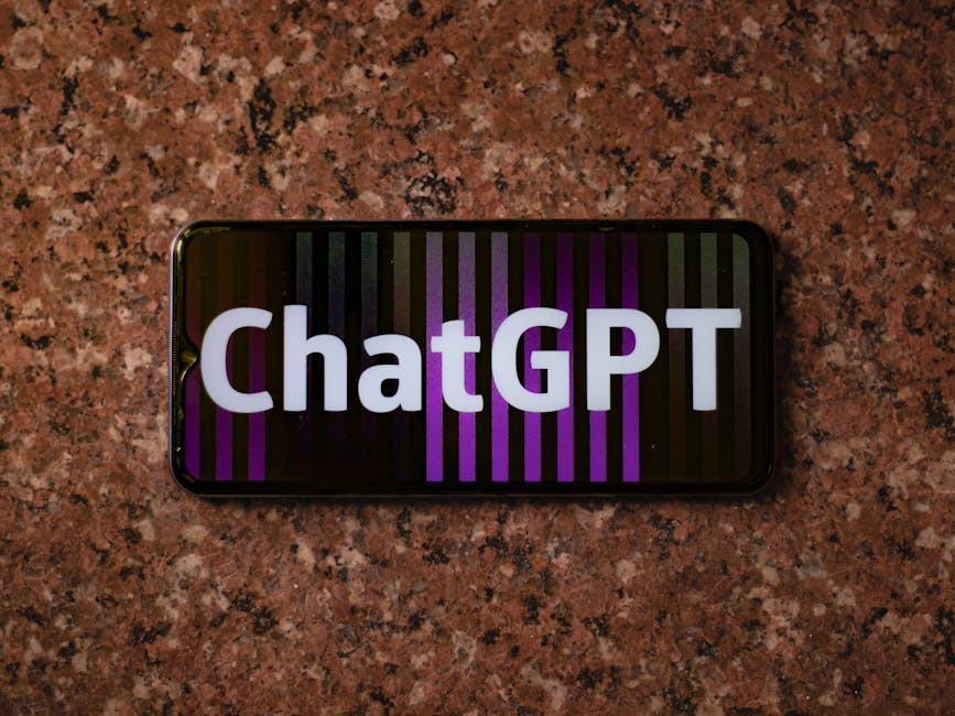 Smartphone displaying ChatGPT on an abstract colorful background, top view.