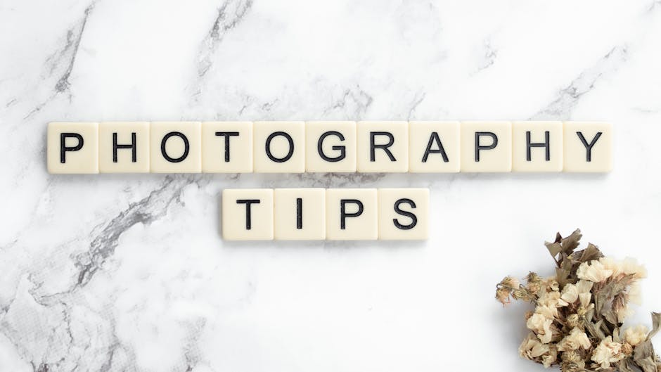 Close-up of the words 'Photography Tips' on a marble surface with dried flowers.