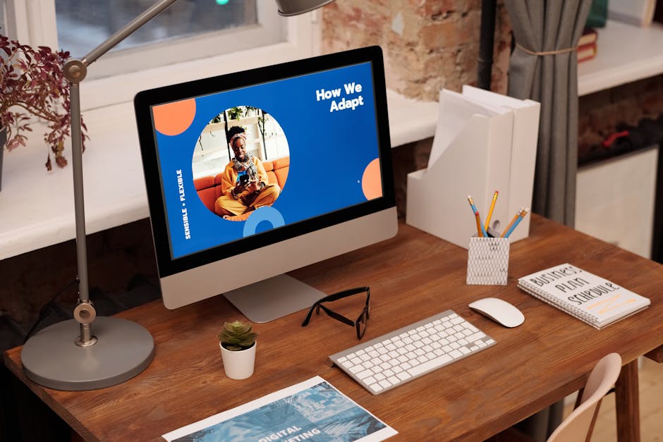 Cozy office setting with a desktop computer displaying 'How We Adapt', showcasing stylish decor and stationery.