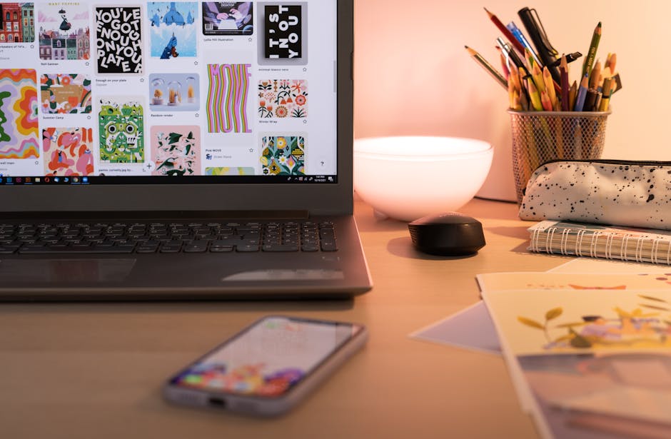 A cozy desk setup with art supplies, laptop, and smartphone, ideal for creative work in Bucharest.