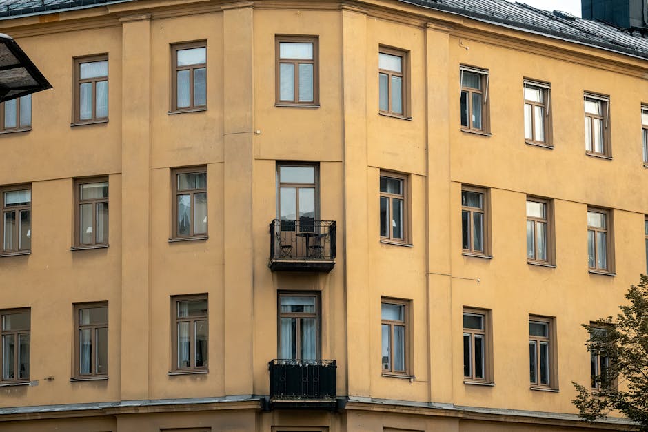 Yellow facade of a classic Swedish apartment building in Stockholm.
